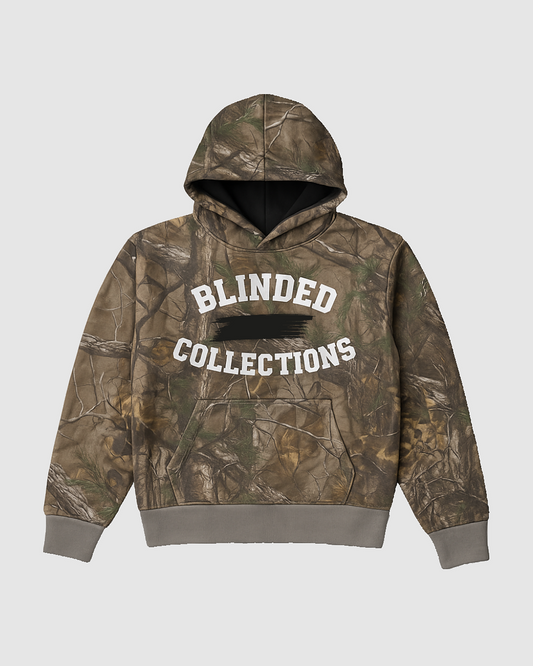Camouflage hoodie with 'Blinded Collections' text on a light gray background